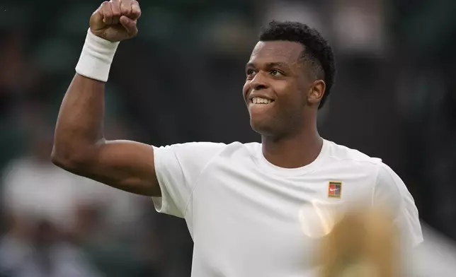 Giovanni Mpetshi Perricard of France reacts during his first round men's single match against Taylor Fritz of the U.S. at the Wimbledon Tennis Championships in London, Monday, June 30, 2025. (AP Photo/Kin Cheung)