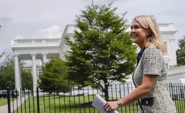 White House press secretary Karoline Leavitt walks to give an interview to Fox News at the White House, Monday, July 21, 2025, in Washington. (AP Photo/Julia Demaree Nikhinson)