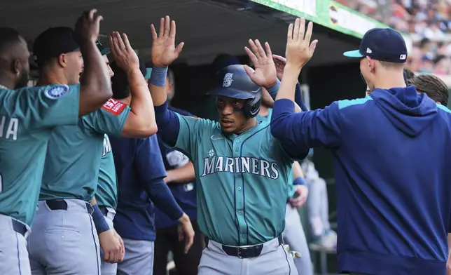 Seattle Mariners' Jorge Polanco celebrates scoring against the Detroit Tigers in the second inning during a baseball game, Friday, July 11, 2025, in Detroit. (AP Photo/Paul Sancya)