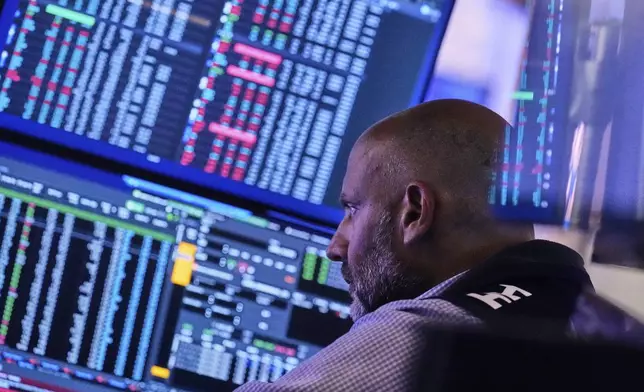 Specialist Meric Greenbaum works at his post on the floor of the New York Stock Exchange, Tuesday, July 8, 2025. (AP Photo/Richard Drew)