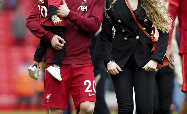 FILE - Liverpool's Diogo Jota walks the pitch with his family after the Premier League match at Anfield, Liverpool, Sunday May 22, 2022. (Peter Byrne/PA via AP, File)