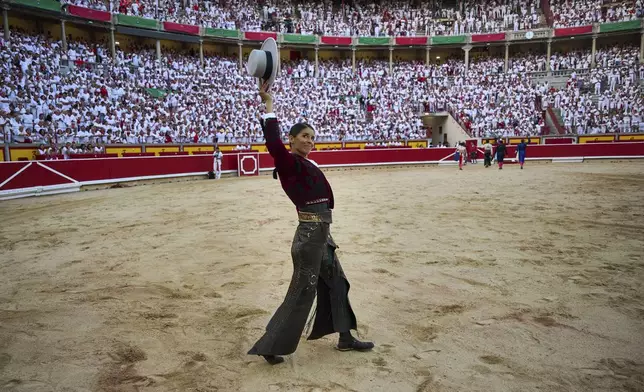 French "rejoneadora," or mounted bullfighter, Lea Vicens greets the crowd during a bullfight on horseback at the San Fermin Festival in Pamplona, northern Spain, on Sunday, July 6, 2025. (AP Photo/Miguel Oses)