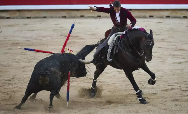 French "rejoneadora," or mounted bullfighter, Lea Vicens performs during a bullfight on horseback at the San Fermin Festival in Pamplona, northern Spain, on Sunday, July 6, 2025. (AP Photo/Miguel Oses)
