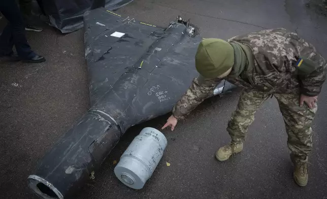 FILE - A Ukrainian officer shows a thermobaric charge from a downed Russian drone in a research laboratory in an undisclosed location in Ukraine on, Nov. 14, 2024. (AP Photo/Efrem Lukatsky, File)
