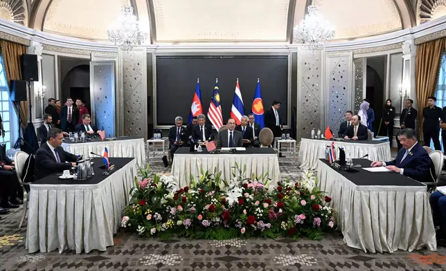 Malaysia's Prime Minister Anwar Ibrahim, center, looks on as Cambodia's Prime Minister Hun Manet, left, and Thailand's acting Prime Minister Phumtham Wechayachai, right, take part in talks on a possible ceasefire between Thailand and Cambodia, in Putrajaya Monday, July 28, 2025. (Mohd Rasfan/Pool Photo via AP)