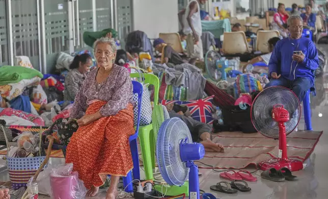 Thai residents who fled homes following the clashes between Thai and Cambodian soldiers rest at an evacuation center in Surin province, Thailand, Monday, July 28, 2025. (AP Photo/Sakchai Lalit)