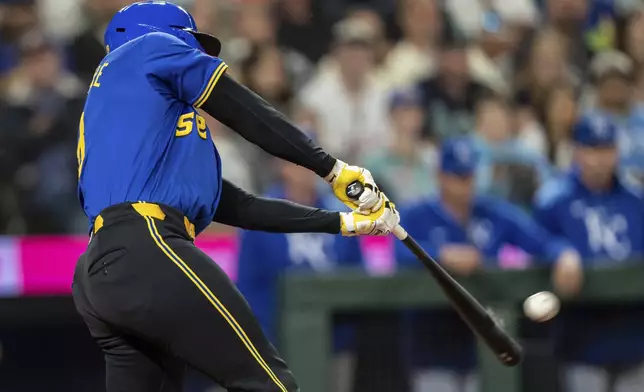 Seattle Mariners' Dominic Canzone hits a solo home run during the ninth inning of a baseball game against the Kansas City Royals, Thursday, July 3, 2025, in Seattle. (AP Photo/Stephen Brashear)