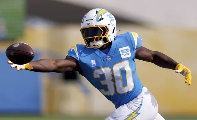 Los Angeles Chargers running back Kimani Vidal reaches for a pass during an NFL football training camp Saturday, July 26, 2025, in El Segundo, Calif. (AP Photo/Eric Thayer)