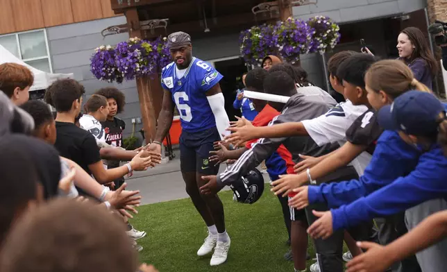 Seattle Seahawks quarterback Jalen Milroe runs out to the field during the NFL football team's training camp Friday, July 25, 2025, in Renton, Wash. (AP Photo/Lindsey Wasson)