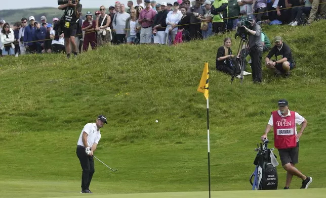 Brian Harman of the United States chips onto the 16th green during the second round of the British Open golf championship at the Royal Portrush Golf Club, Northern Ireland, Friday, July 18, 2025. (AP Photo/Jon Super)