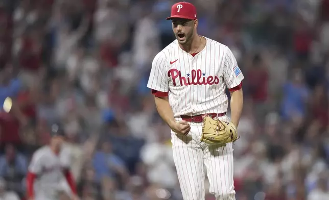 Philadelphia Phillies pitcher Max Lazar reacts after striking out Boston Red Sox's Roman Anthony during the 10th inning of a baseball game Monday, July 21, 2025, in Philadelphia. (AP Photo/Matt Slocum)