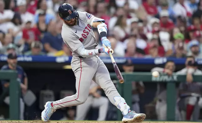 Boston Red Sox's Trevor Story hits a run-scoring single agains tPhiladelphia Phillies pitcher Zack Wheeler during the sixth inning of a baseball game Monday, July 21, 2025, in Philadelphia. (AP Photo/Matt Slocum)