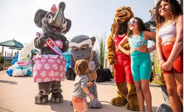 Guests are greeted by Kalahari characters during the poolside celebration on National Waterpark Day.