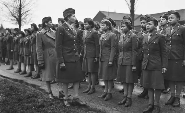 In this photo provided by the National Archives, Maj. Charity E. Adams and Capt. Mary Kearney, of the 6888th Central Postal Directory Battalion, inspect the first contingent of Black members of the Women's Army Corps assigned to overseas service in England on Feb. 15, 1945. (Holt/U.S. Army via AP)