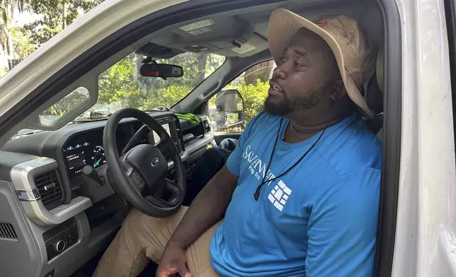 Darius Cowherd takes a break from his city landscaping job in Savannah, Ga., Tuesday, July 29, 2025, as people across the South dealt with extreme summer heat. (AP Photo/Russ Bynum)