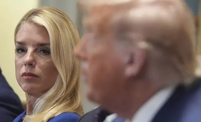 Attorney General Pam Bondi, left, listens as President Donald Trump, right, speaks during a cabinet meeting at the White House, Tuesday, July 8, 2025, in Washington. (AP Photo/Evan Vucci)