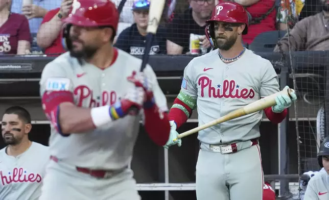 Philadelphia Phillies' Bryce Harper, right, watches Chicago White Sox starting pitcher Davis Martin (not shown) during the first inning of a baseball game in Chicago, Monday, July 28, 2025. (AP Photo/Nam Y. Huh)