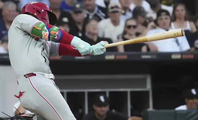 Philadelphia Phillies' Bryce Harper hits a two-run double during the third inning of a baseball game against the Chicago White Sox in Chicago, Monday, July 28, 2025. (AP Photo/Nam Y. Huh)