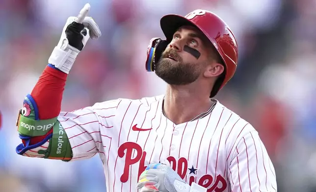 Philadelphia Phillies' Bryce Harper reacts after hitting a home run against Boston Red Sox pitcher Lucas Giolito during the first inning of a baseball game Wednesday, July 23, 2025, in Philadelphia. (AP Photo/Matt Slocum)