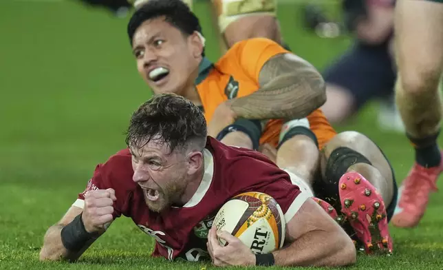 Hugo Keenan of the British &amp; Irish Lions celebrates after scoring the winning try during the second rugby union test against Australia at the Melbourne Cricket Ground in Melbourne, Australia, Saturday, July 26, 2025. (AP Photo/Asanka Brendon Ratnayake)