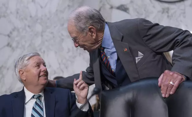 Senate Judiciary Committee Chairman Chuck Grassley, R-Iowa, right, greets Sen. Lindsey Graham, R-S.C., as the panel meets to advance President Donald Trump's nominees for the federal bench, including Emil Bove, Trump's former defense lawyer, at the Capitol in Washington, Thursday, July 17, 2025. (AP Photo/J. Scott Applewhite)