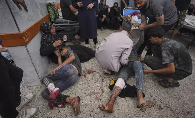Wounded Palestinians are brought to Shifa Hospital in Gaza City after being injured while on their way to an aid distribution center, Thursday, July 3, 2025. (AP Photo/Jehad Alshrafi)