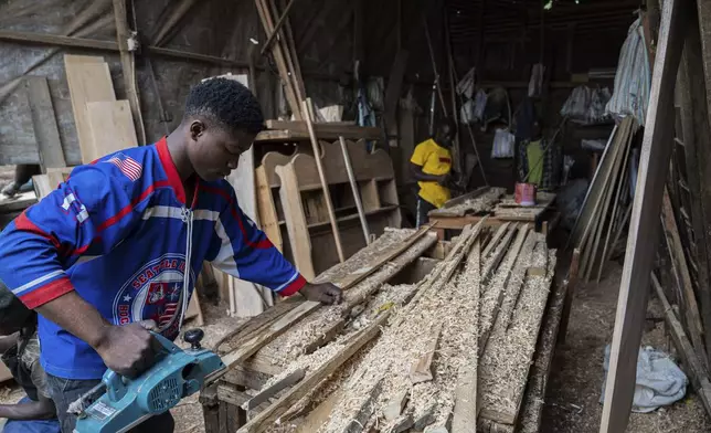 Diode works in a carpentry shop powered in part by solar energy in Goma, Congo, May 23, 2024. (AP Photo/Moses Sawasawa)