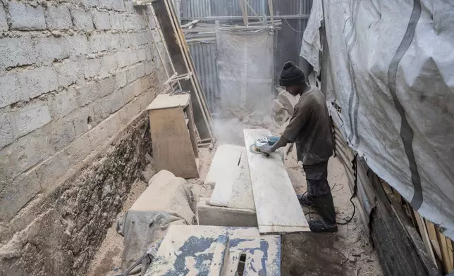 Isaac works in a carpentry shop that is powered in part by solar energy in Goma, Congo, May 23, 2025. (AP Photo/Moses Sawasawa)