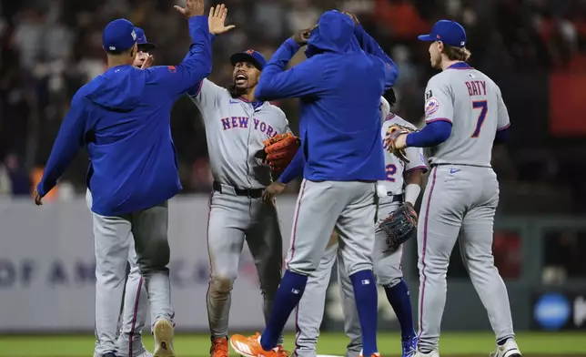 New York Mets shortstop Francisco Lindor, third from left, celebrates with teammates after their victory over the San Francisco Giants in a baseball game Saturday, July 26, 2025, in San Francisco. (AP Photo/Godofredo A. Vásquez)