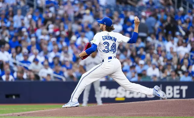 Toronto Blue Jays pitcher Kevin Gausman throws against the New York Yankees during first-inning baseball game action in Toronto, Monday, July 21, 2025. (Thomas Skrlj/The Canadian Press via AP)