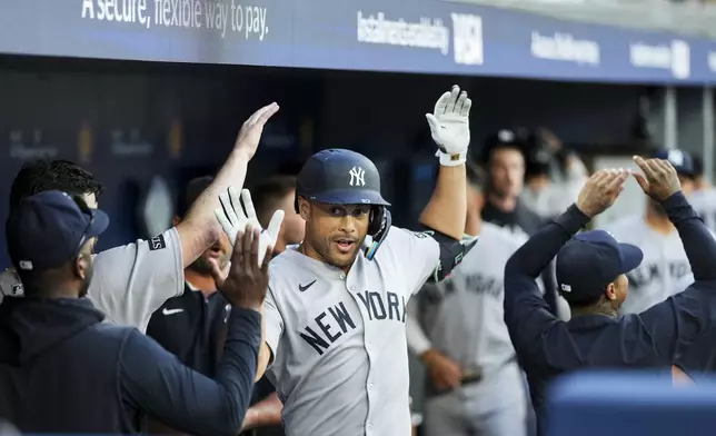 New York Yankees designated hitter Giancarlo Stanton celebrates with teammates after a home run against the Toronto Blue Jays during fourth-inning baseball game action in Toronto, Monday, July 21, 2025. (Thomas Skrlj/The Canadian Press via AP)