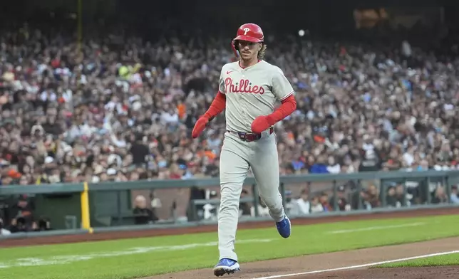Philadelphia Phillies' Bryson Stott scores on a wild pitch by San Francisco Giants pitcher Landen Roupp during the fifth inning of a baseball game in San Francisco, Monday, July 7, 2025. (AP Photo/Jeff Chiu)