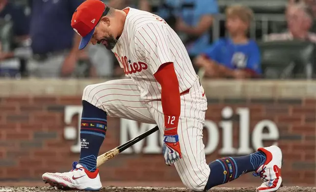 Philadelphia Phillies Kyle Schwarber celebrates after winning the tiebreaker at the MLB baseball All-Star game between the American League and National League, Tuesday, July 15, 2025, in Atlanta. (AP Photo/Mike Stewart)