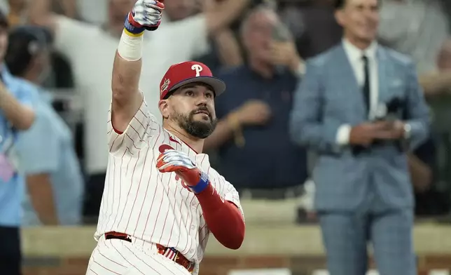 Philadelphia Phillies Kyle Schwarber celebrates after winning the tiebreaker at the MLB baseball All-Star game between the American League and National League, Tuesday, July 15, 2025, in Atlanta. (AP Photo/Brynn Anderson)