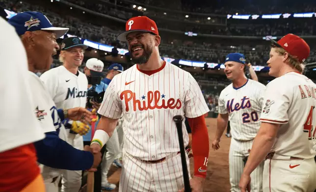 Philadelphia Phillies Kyle Schwarber celebrates after winning the tiebreaker at the MLB baseball All-Star game between the American League and National League, Tuesday, July 15, 2025, in Atlanta. (AP Photo/Brynn Anderson)