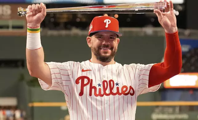Philadelphia Phillies Kyle Schwarber celebrates after winning the tiebreaker at the MLB baseball All-Star game between the American League and National League, Tuesday, July 15, 2025, in Atlanta. (AP Photo/Brynn Anderson)