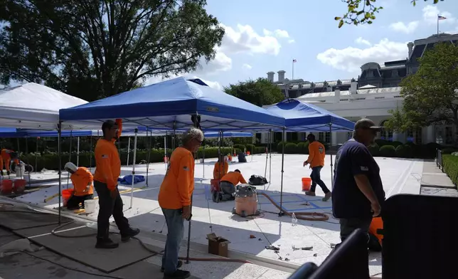 Construction work continues in the Rose Garden before President Donald Trump departs the White House, Thursday, July 24, 2025, in Washington. (AP Photo/Julia Demaree Nikhinson)