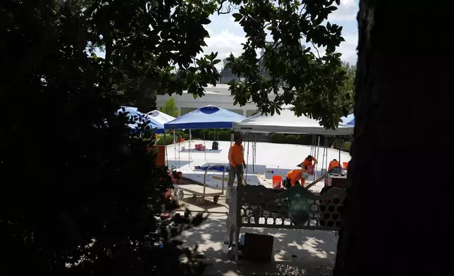 Construction work continues in the Rose Garden before President Donald Trump departs the White House, Thursday, July 24, 2025, in Washington. (AP Photo/Julia Demaree Nikhinson)