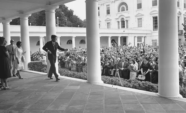 FILE - President John Kennedy walks toward the microphones on the White House portico outside his office on July 13, 1961 in Washington to address a group of 1,827 teenagers from 51 countries, exchange students who have been in the United States the past year. The students jammed the Rose Garden. Some were pushed to the ground in a surge to get closer to the President. (AP Photo/JR, File)