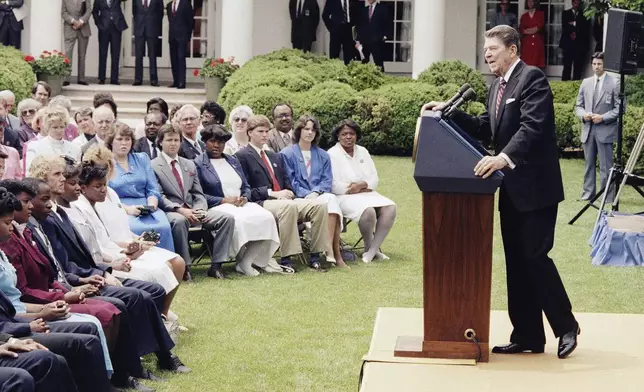 FILE - President Ronald Reagan delivers the commencement speech to the John A. Holmes High School senior class from Edenton, N.C., May 13, 1986 in Washington in the Rose Garden of the White House. (AP Photo/Scott Stewart, File)