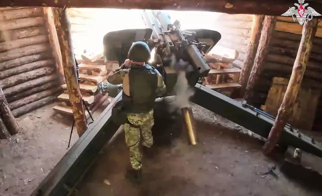 In this photo taken from video distributed by Russian Defense Ministry Press Service on Wednesday, July 16, 2025, a Russian soldier fires a 152 mm howitzer 2A65 Msta-B towards Ukrainian position in an undisclosed location in Ukraine. (Russian Defense Ministry Press Service via AP)