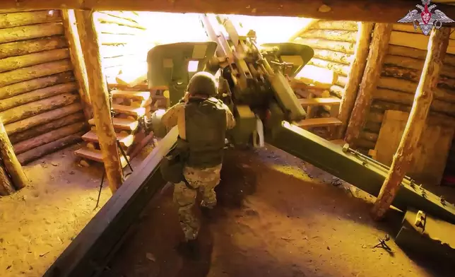 In this photo taken from video distributed by Russian Defense Ministry Press Service on Wednesday, July 16, 2025, a Russian soldier fires a 152 mm howitzer 2A65 Msta-B towards Ukrainian position in an undisclosed location in Ukraine. (Russian Defense Ministry Press Service via AP)