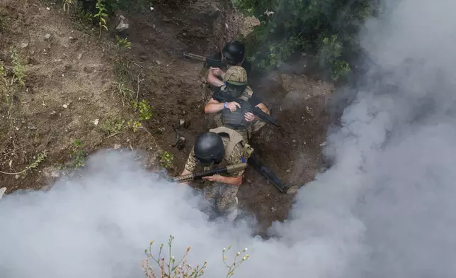 Ukrainian 3rd Assault Brigade recruits train at the polygon in Kyiv region, Ukraine, on Wednesday, July 16, 2025. (AP Photo/Evgeniy Maloletka)