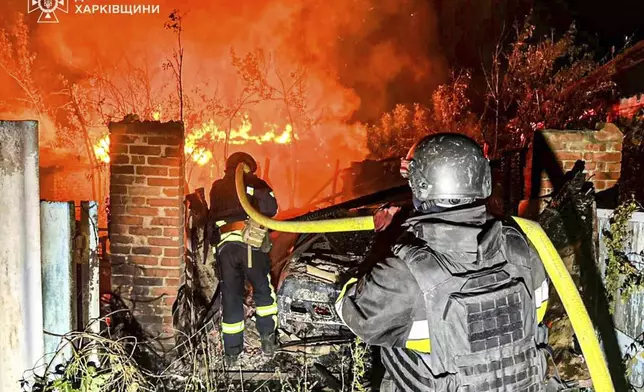 FILE - In this photo provided by the Ukrainian Emergency Service, firefighters try to put out a fire following a Russian attack in the Kharkiv region of Ukraine, Tuesday, July 15, 2025. (Ukrainian Emergency Service via AP, File)