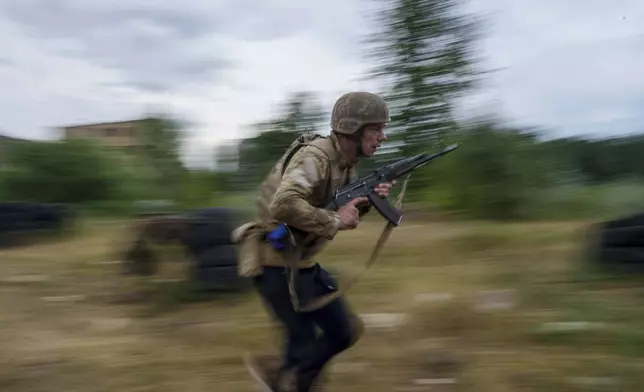 Ukrainian military recruits train at the polygon in the Kyiv region, Ukraine, Wednesday, July 16, 2025. (AP Photo/Evgeniy Maloletka)