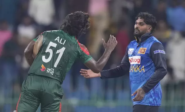 Sri Lanka's Wanindu Hasaranga and Bangladesh's Jaker Ali congratulate each others after the first ODI cricket match between Sri Lanka and Bangladesh in Colombo, Sri Lanka, Wednesday, July 2, 2025. (AP Photo/Eranga Jayawardena)