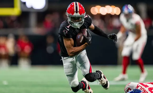 FILE - Atlanta Falcons wide receiver Darnell Mooney (1) runs the ball during the first half of an NFL football game against the New York Giants, Sunday, Dec. 22, 2024, in Atlanta. (AP Photo/Danny Karnik,File)
