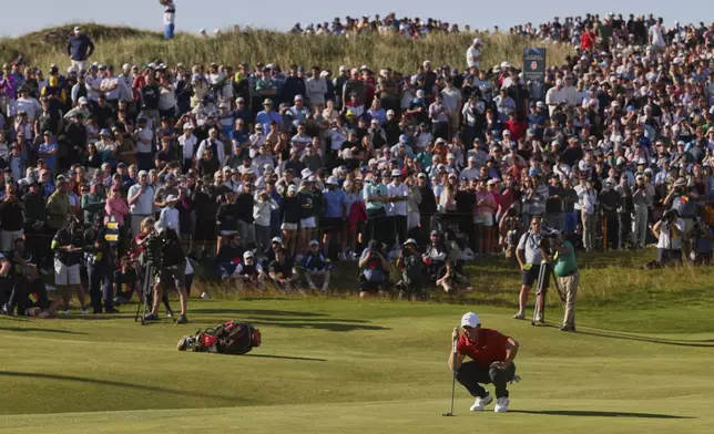 Rory McIlroy of Northern Ireland looks at the line of his putt on the 17th hole during the third round of the British Open golf championship at the Royal Portrush Golf Club, Northern Ireland, Saturday, July 19, 2025. (AP Photo/Peter Morrison)