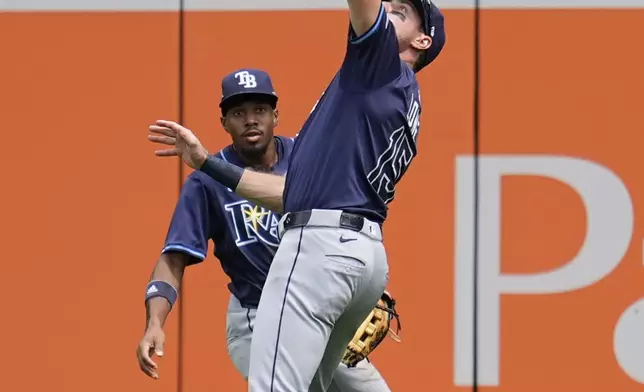 Tampa Bay Rays right fielder Josh Lowe (15) catches a fly out hit by Minnesota Twins' Willi Castro (50) during the third inning of a baseball game Saturday, July 5, 2025, in Minneapolis. (AP Photo/Abbie Parr)