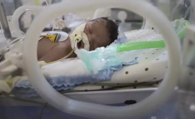 Newborn Soad Qeshtah seen in an incubator in Nasser Hospital in Khan Younis, hours before she died. Her mother, who was seven months pregnant, was killed in an Israeli airstrike in the Gaza Strip and the baby was delivered by emergency cesarean section, Monday, July 28, 2025. (AP Photo/Mariam Dagga)